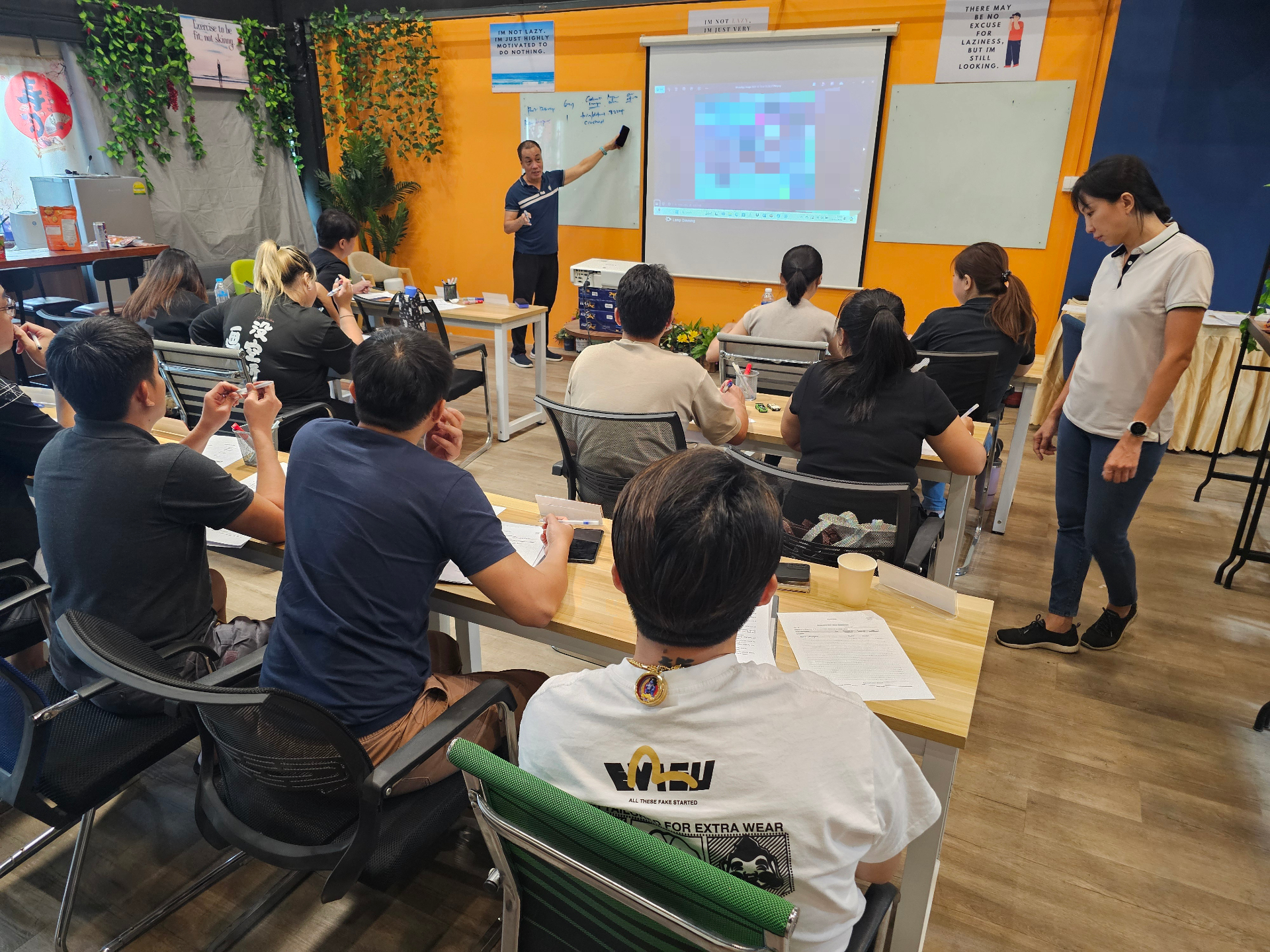 Participants attending an Igive classroom training session with an instructor presenting at the front.