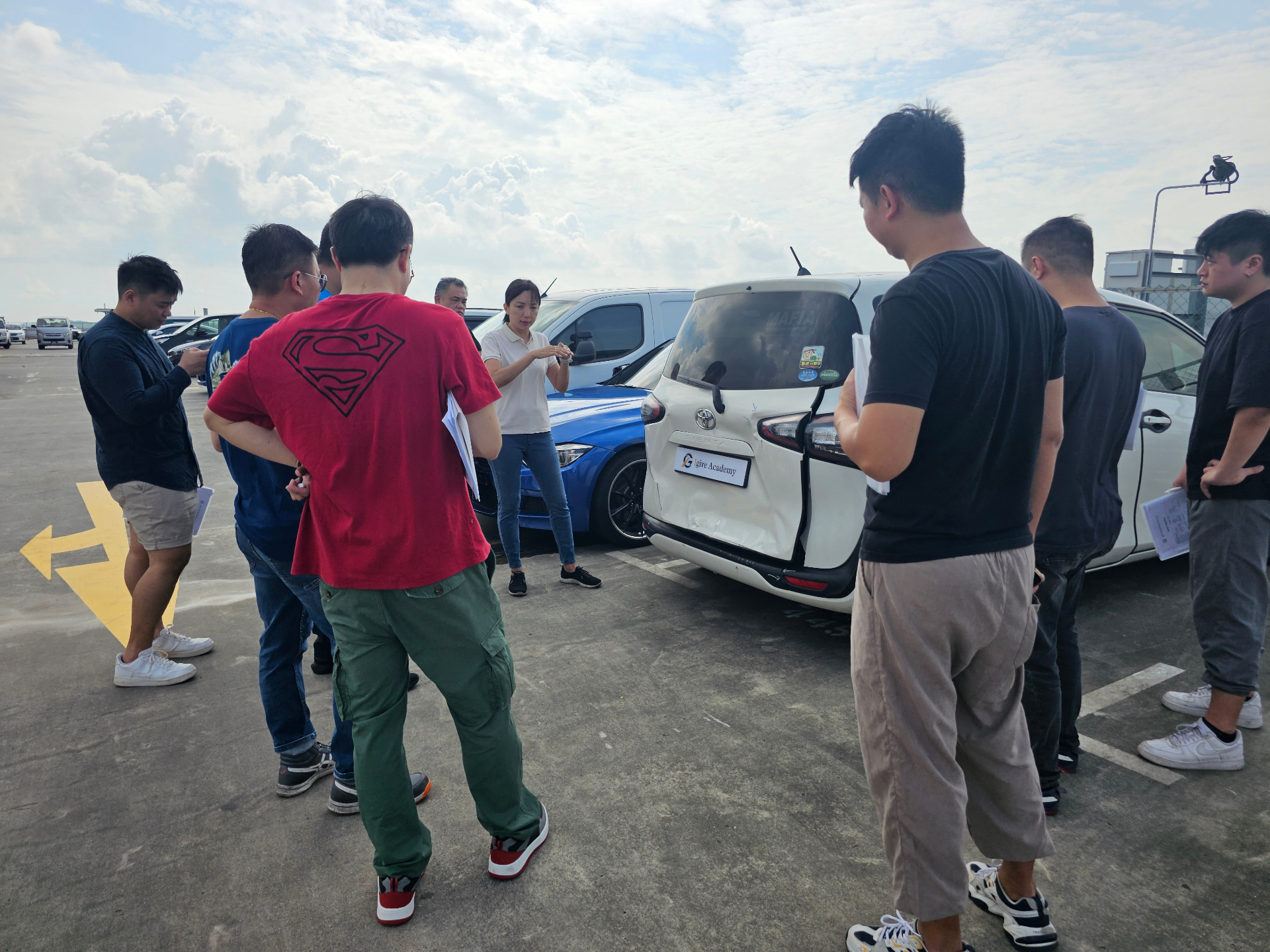 Participants gathered around a vehicle during outdoor field training led by Igive.