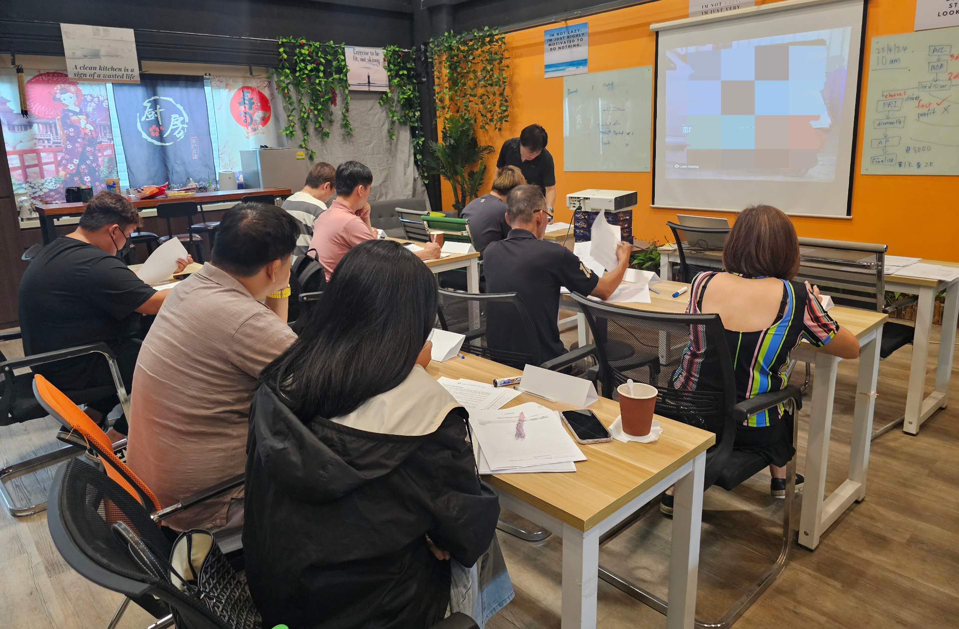 Corporate training participants seated in class reviewing materials during an Igive session.